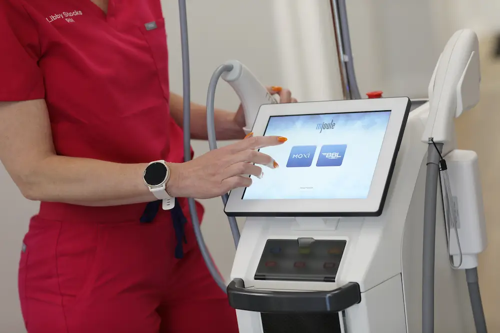 Nurse operating advanced laser treatment equipment